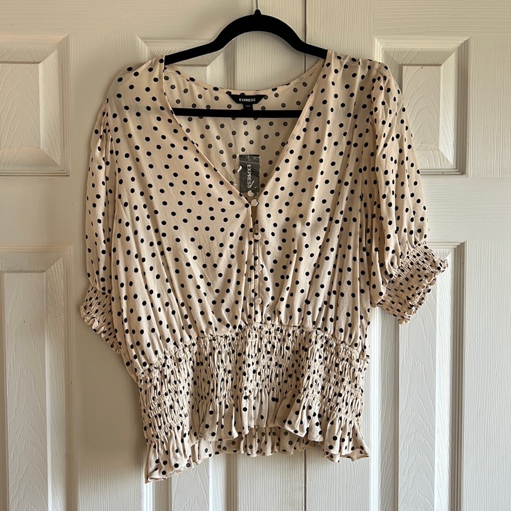 NWT Never worn beautiful cream and black ruched peplum top!
